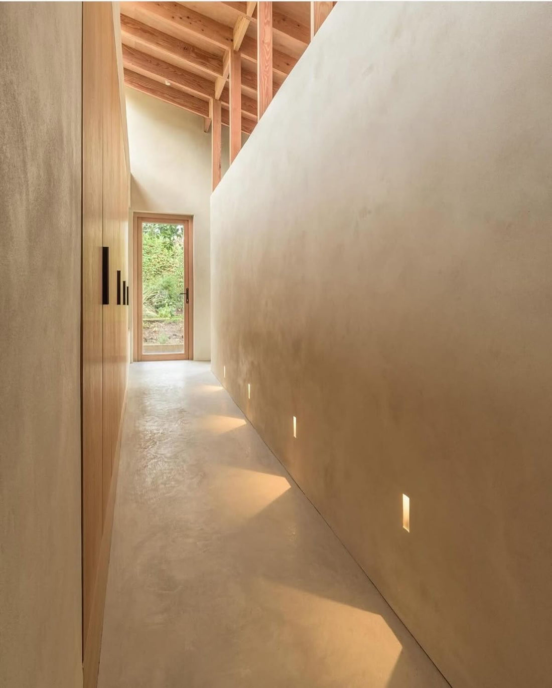 Curved microcement wall running into the floor
